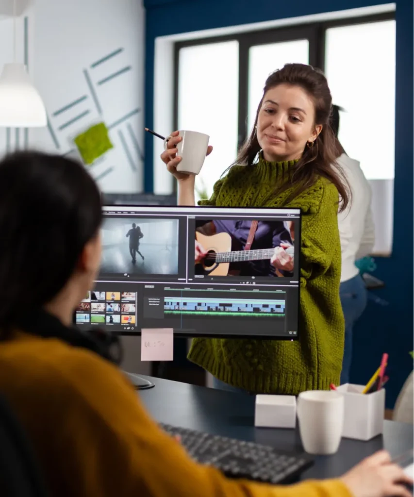 Creative professionals collaborating on video editing project in a modern office environment
